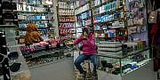 URUMQI, XINJIANG UYGUR AUTONOMOUS REGION, CHINA - 2016/06/18: A Uygur woman is choosing cosmetic in a beauty goods shop. The Xinjiang International Grand Bazaar, an Islamic bazaar in Ürümqi, is the largest bazaar in the world by scale and one of the most famous landmarks in this city. (Photo by Zhang Peng/LightRocket via Getty Images)