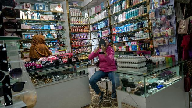 URUMQI, XINJIANG UYGUR AUTONOMOUS REGION, CHINA - 2016/06/18: A Uygur woman is choosing cosmetic in a beauty goods shop. The Xinjiang International Grand Bazaar, an Islamic bazaar in Ürümqi, is the largest bazaar in the world by scale and one of the most famous landmarks in this city. (Photo by Zhang Peng/LightRocket via Getty Images)