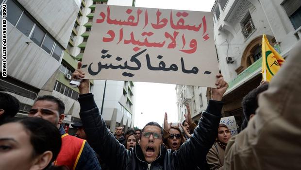 A Moroccan supporter of the February 20 pro-reform movement holds a placard meaning in Arabic "Stop corruption. We will not give up" during a demonstration to mark the fifth anniversary the movement's creation, on February 20, 2016 in the capital Rabat. Several hundred protesters took part in the demonstration to mark the anniversary of the creation of the pro-reform movement, that was born during the Arab Spring, and called for social justice and change. / AFP / FADEL SENNA (Photo credit should read FADEL SENNA/AFP/Getty Images)