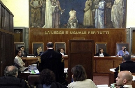This picture taken with a smartphone shows Moroccan-born Karima El-Mahroug, nicknamed "Ruby the Heart Stealer" (L), during a session of former Prime Minister Silvio Berlusconi's trial for having sex with an underage prostitute and abuse of office on May 24, 2013 at Milan's tribunal.The hearing is one of the last in a trial that began two years ago and relates to alleged crimes in 2010 when Berlusconi was still prime minister and revolves around alleged raunchy "bunga bunga" parties at his luxury residence outside Milan. AFP PHOTO / OLIVIER MORIN BEST QUALITY AVAILABLE