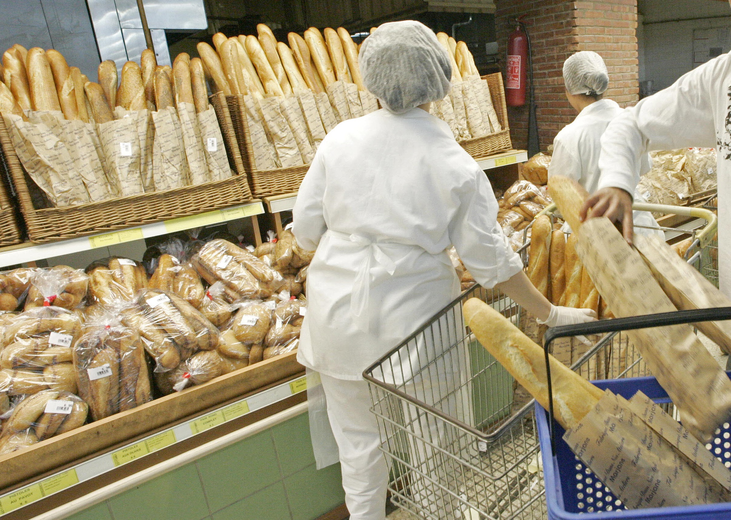 A Moroccan buys bread at a supermarket on April 4, 2008 in Rabat. During the first two months of 2008 prices in Morocco have risen, cooking oil by 8%, semolina for couscous by 12.1%, pasta by 8.7%, soft flour by 6.7%, hard flour by 17.3% and 14% for corn according to the Moroccan census bureau (HCP). In Egypt, there is a serious bread crisis brought on by a combination of the rising cost of wheat on world markets and sky-rocketing inflation, and the price of bread has increased fivefold in private bakeries. EU Development Commissioner Louis Michel warned on April 8, 2008 that soaring prices of basic foodstuffs in Africa could cause a "humanitarian tsunami". AFP PHOTO/ABDELHAK SENNA