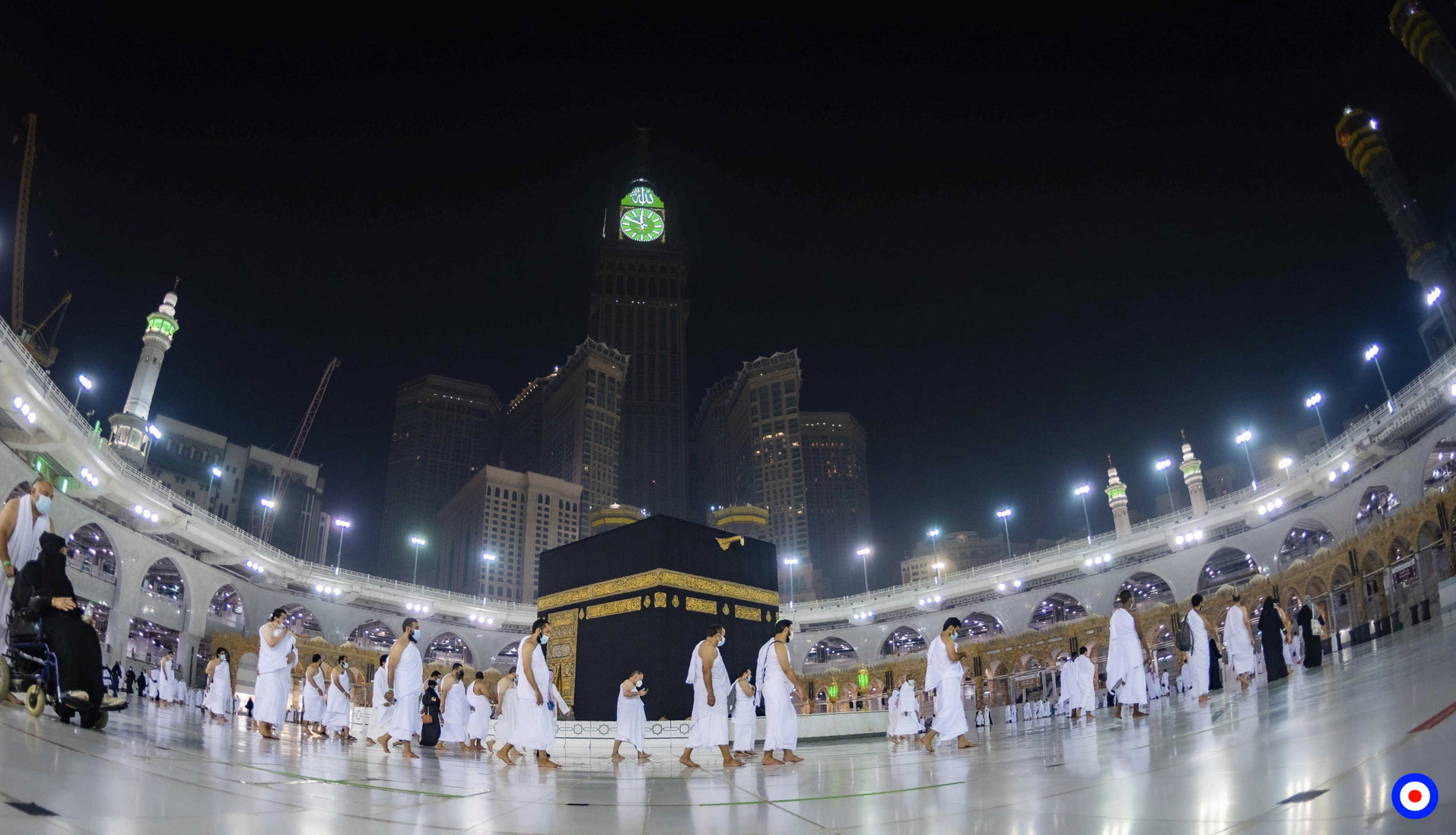 In this photo released by Saudi Ministry of Hajj and Umrah, Muslims pray around the Kaaba, the cubic building at the Grand Mosque, during the first day of Umrah in the Muslim holy city of Mecca, Saudi Arabia, Sunday, Oct. 4, 2020. A very small, limited number of people donning the white terrycloth garment symbolic of the Muslim pilgrimage circled Islam's holiest site in Mecca on Sunday after Saudi Arabia lifted coronavirus restrictions that had been in place for months. (Saudi Ministry of Hajj and Umrah via AP)